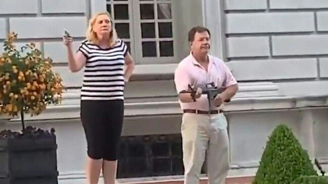 St Louis residents Mark and Patricia McCloskey brandish guns as Black Lives Matter protesters peacefully march past their mansion. Picture: AFP /Daniel Shular via Eurovision