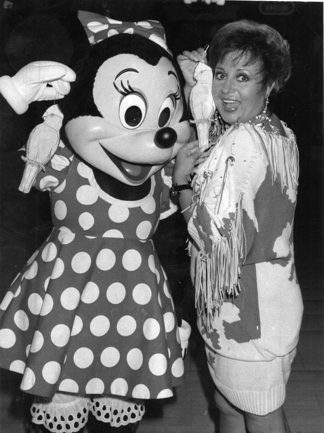 1989: Wills presents Disney character Minnie Mouse with a big, gaudy, bright pair of galah earrings during Myer-Disneyland Down Under visit to Adelaide, April, 1989.