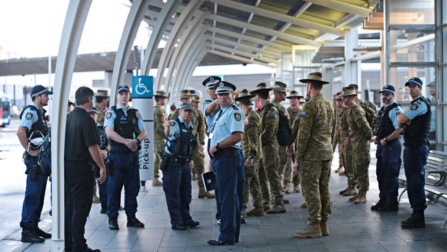 Heavy police and army presence for the first lot of international arrivals landing and being put on buses heading to hotels to be quarantined at Sydney international airport on the 29th of March 2020.