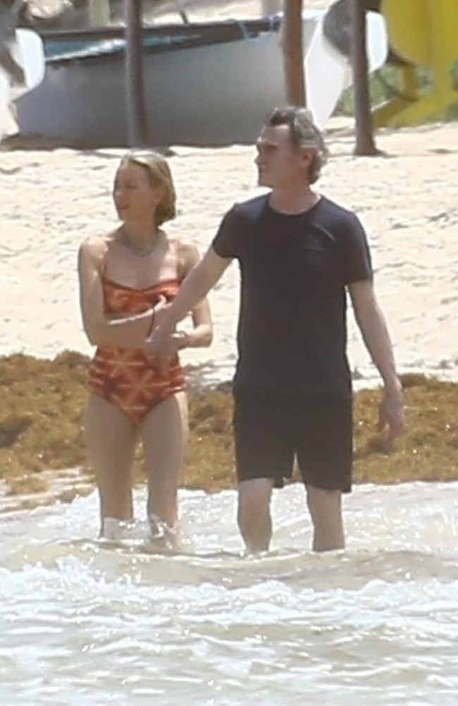 The happy couple were seen holding hands and frolicking together in the ocean. Picture: Backgrid.