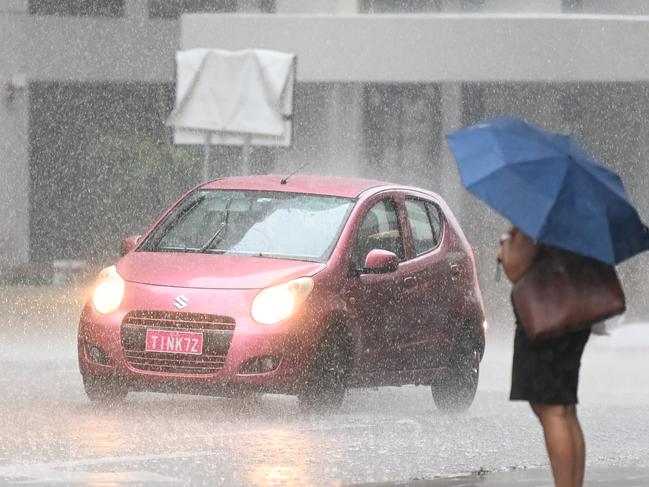 BRISBANE, AUSTRALIA - NewsWire Photos - FEBRUARY 2, 2021.People make their way through heavy rain in central Brisbane. A severe thunderstorm warning with possible flash flooding has been issued for the southeast, including Brisbane CBD, as wet weather causes traffic chaos on Tuesday morning.Picture: NCA NewsWire / Dan Peled