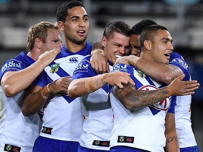 Kerrod Holland (centre) celebrates a try with teammates. Picture: AAP