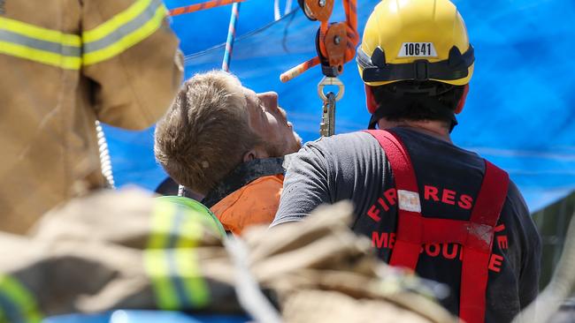 A worker is rescued from a collapsed trench in Epping. Picture: Ian Currie