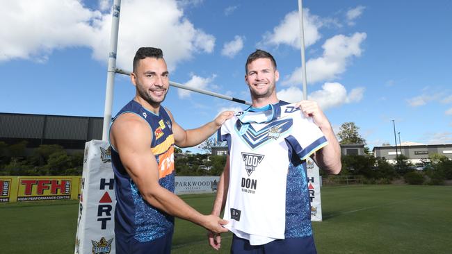 Titans players Anthony Don and Ryan James with the new jerseys the club will hand to all players with 100 games this weekend. Picture: Richard Gosling