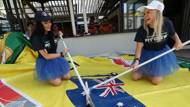 Story Bridge Hotel staffers Annalise Hayes, left, and Rhianna Gaden prepare for the Australia Day cockroach races. Picture: Lyndon Mechielsen