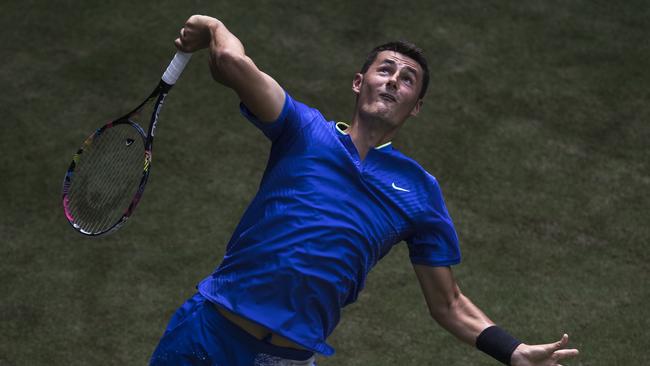 Bernard Tomic of Australia serves during his match.