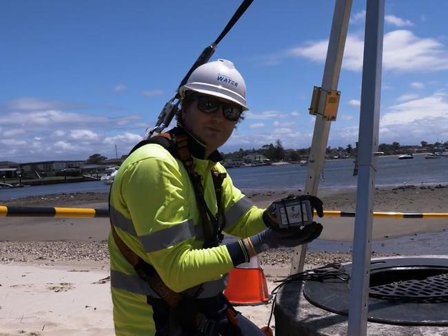 Sydney Water worker installing an IoT sensor.