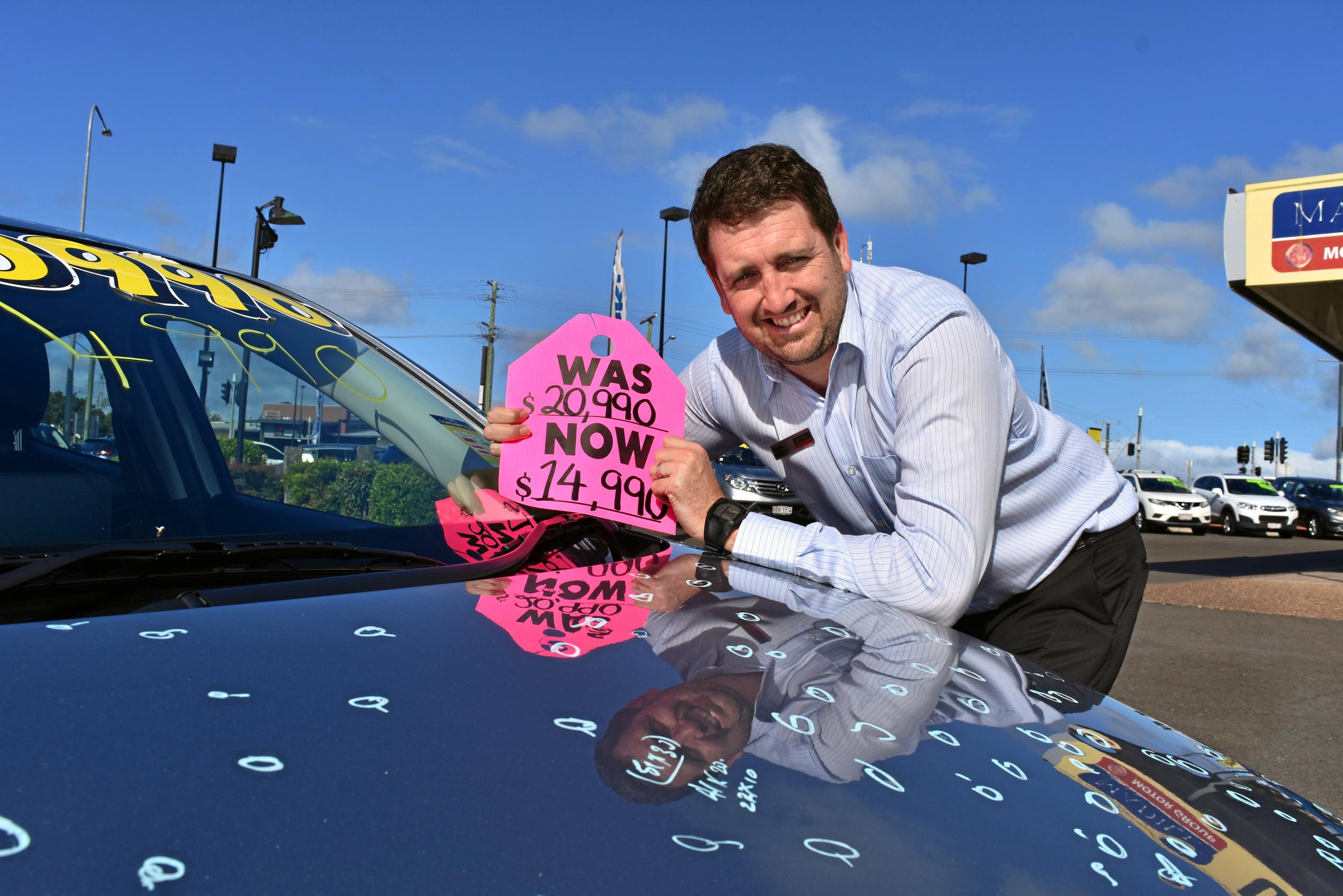 Adam Madill has had to drastically reduce the prices of cars in the lot because of hail damage. Picture: DONNA JONES