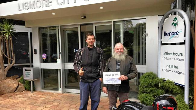 Kyogle's Peter 'Kog' Godfrey and his son, James making a generous donation of money raised from the showing of their film to the Lismore Council Flood Appeal. Picture: Samantha Poate