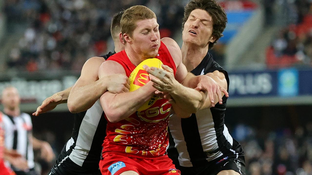 GOLD COAST, AUSTRALIA - JULY 01: Matt Rowell of the Suns is tackled by Brody Mihocek and Taylor Adams of the Magpies during the 2023 AFL Round 16 match between the Gold Coast Suns and the Collingwood Magpies at Heritage Bank Stadium on July 1, 2023 in the Gold Coast, Australia. (Photo by Russell Freeman/AFL Photos via Getty Images)