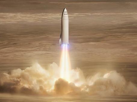 This artist's rendering made available by Elon Musk on Friday, Sept. 29, 2017 shows SpaceX's new mega-rocket design on Mars. With the 350-foot-tall spacecraft, Musk announced that his private space company aims to launch two cargo missions to the red planet in 2022. (SpaceX via AP)