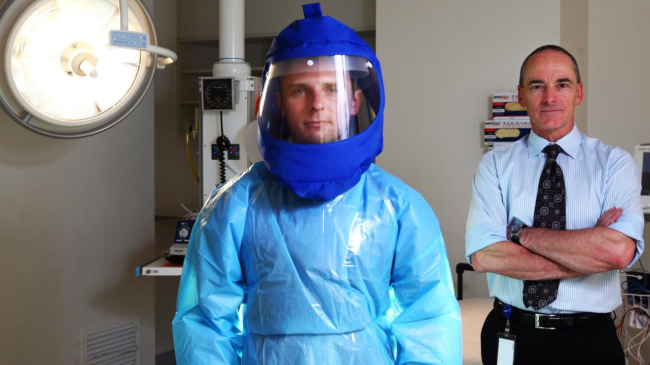 Peter Doherty Institute deputy director Dr Mike Catton (right) pictured with clinical nurse specialist Ben Smith in an isolation suit.