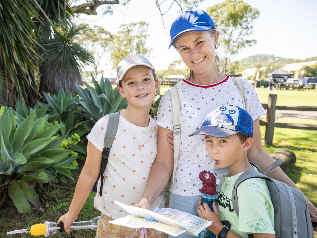 Millie, Melanie and Ned Hutchinson plan their day at the Toowoomba Royal Show. Friday, March 25, 2022. Picture: Nev Madsen.