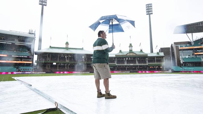Curator Adam Lewis looks out at a wet SCG which will likely result in the washout of the Big Bash final Picture: John Feder