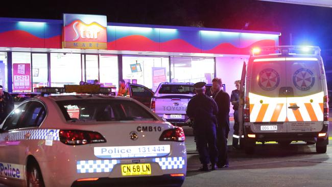 Police swamp the Star Mart petrol station. Picture: Bill Hearne