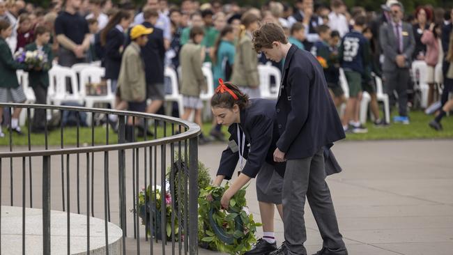 Students laying wreaths at the Eternal Flame during the ceremony.