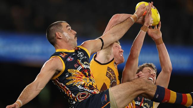 Taylor Walker of the Crows attempts to mark.