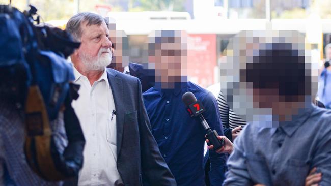 Barrister Bill Boucaut SC, left, escorts the diarist, centre, from court.