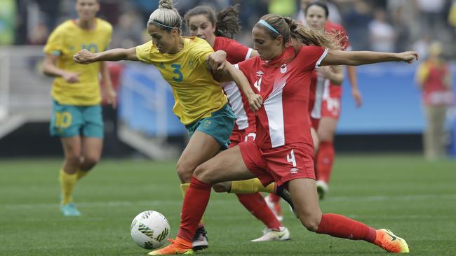 Australia's Katrina Gorry, left, fights for the ball with Canada's Shelina Zadorsky during the 2016 Summer Olympics football match at the Arena Corinthians in Sao Paulo, Brazil, Wednesday, Aug. 3, 2016. (AP Photo/Nelson Antoine)