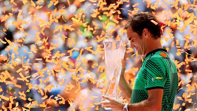 Roger Federer holds the winner's trophy after defeating Rafael Nadal,