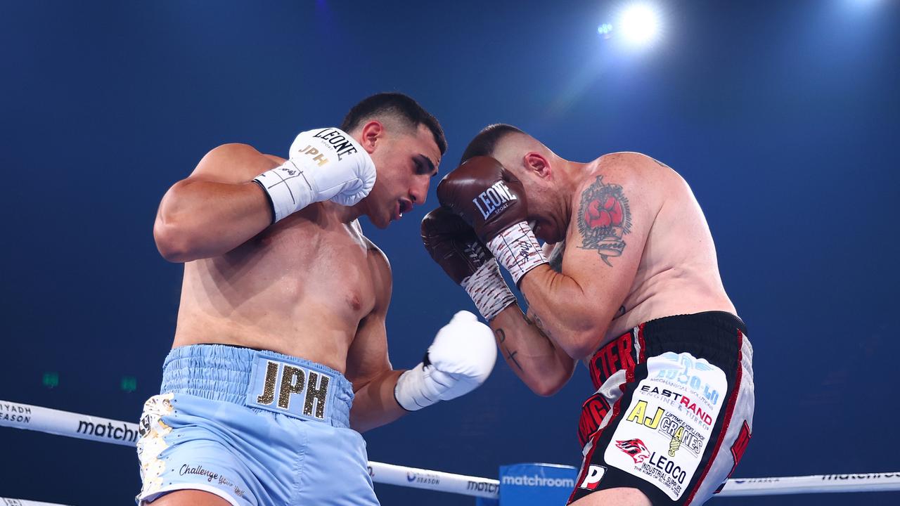 Justis Huni (left) punches Shaun Potgieter during his one-sided victory. (Photo by Chris Hyde/Getty Images)