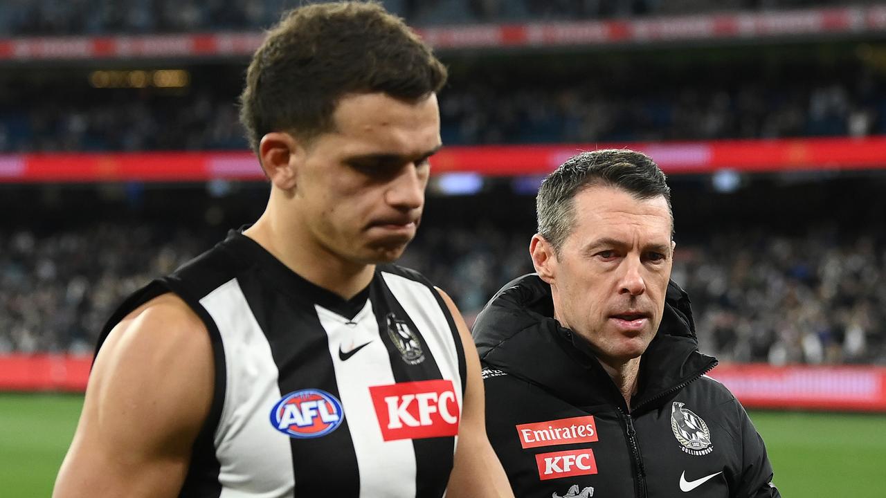 Ash Johnson and coach Craig McRae walk off the MCG. Picture: Quinn Rooney/Getty Images