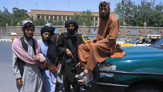 Taliban fighters pose as they stand guard along the roadside in Herat. Picture: AFP