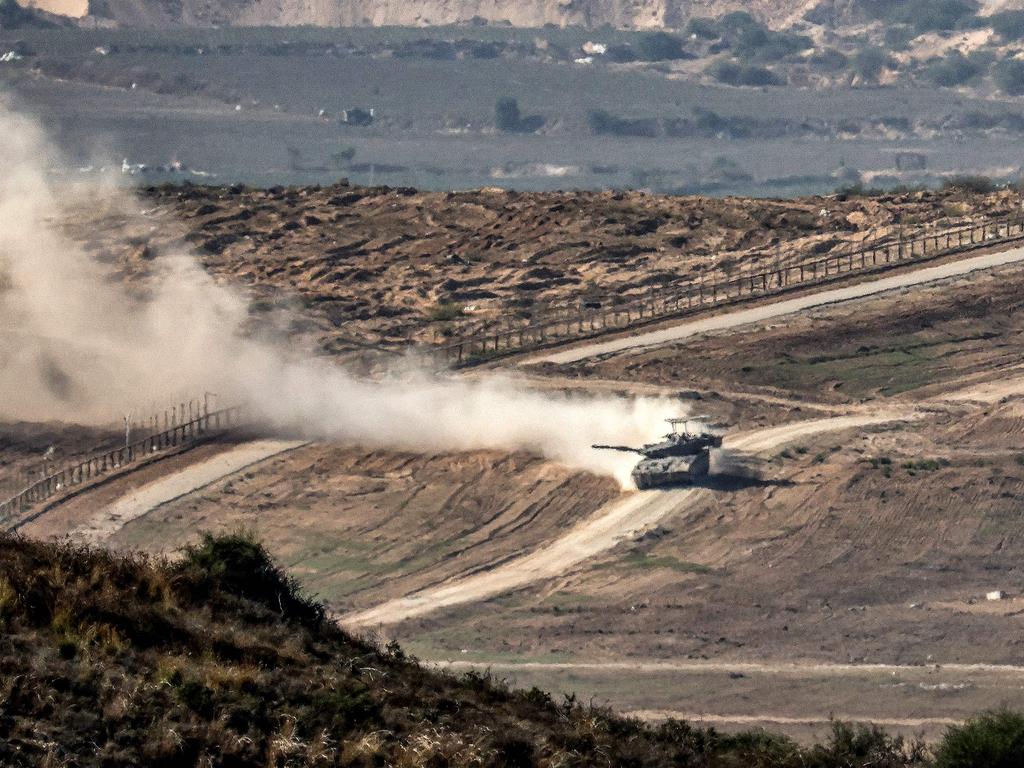 n Israeli army battle moves at a position near a barbed wire fence along the border with the Gaza Strip and southern Israel. Picture: AFP