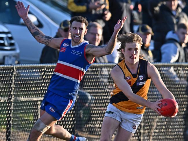 EDFL: Strathmore’s Kyle Weightman skips away of Jesse Wallin of Keilor. Picture: Andy Brownbill