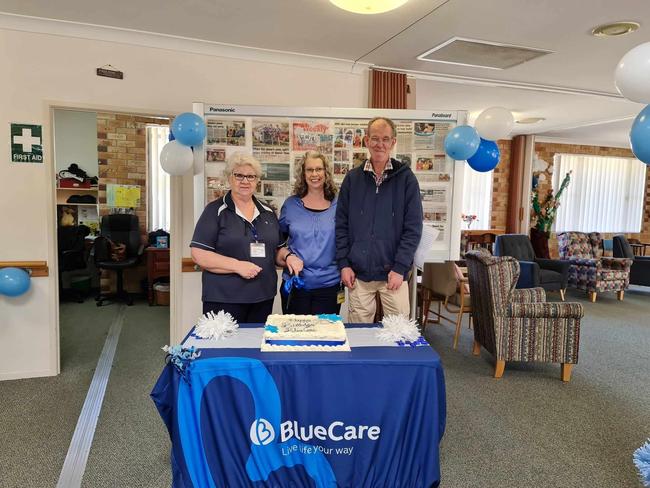 BlueCare Warwick staff Lynne Wood (L), Vivienne Blackwood and long-term client Darryl Sinkins (R) cutting the cake for BlueCare's 70th anniversary.