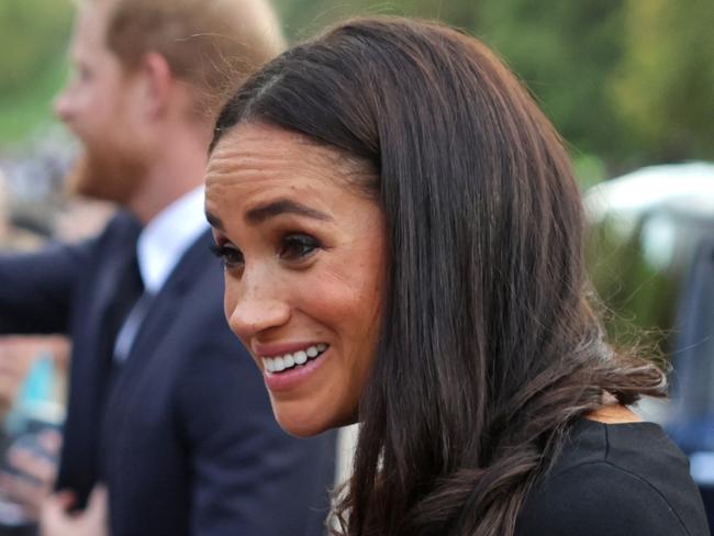 WINDSOR, ENGLAND - SEPTEMBER 10: Meghan Duchess of Sussex speaks with well-wishers at Windsor Castle on September 10, 2022 in Windsor, England. Crowds have gathered and tributes left at the gates of Windsor Castle to Queen Elizabeth II, who died at Balmoral Castle on 8 September, 2022. (Photo by Chris Jackson - WPA Pool/Getty Images)