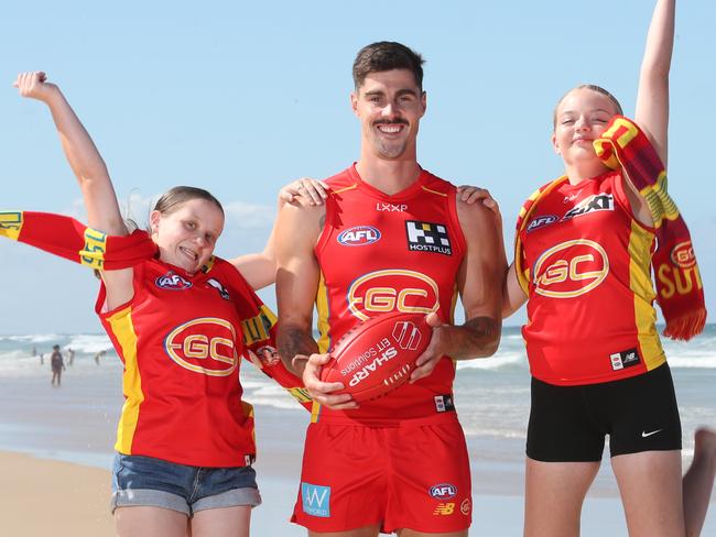 Primed for a big weekend of sport for the Gold Coast Suns are player Alex Sexton and fans Kayla Smith and Bonnie Stott.. Picture Glenn Hampson