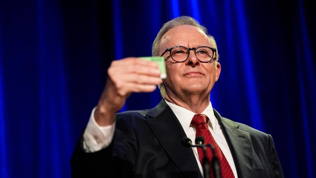 Anthony Albanese holds up his Medicare card during the Labor Party’s election victory party on May 3. Picture: Getty Images