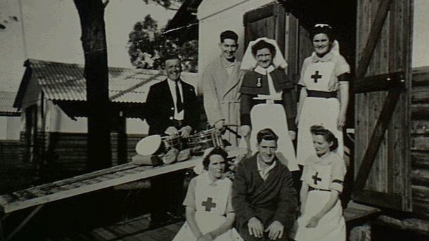 Voluntary Aid Detachment nurses with some patients outside a hut at the hospital site in 1945.