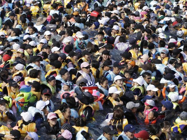 People crowd in the Caribbean Bay swimming pool trying to escape the heat in Yongin, South Korea, Thursday, Aug. 2, 2018. South Korean Meteorological Administration issued a heat wave warning for Seoul and other cities. (AP Photo/Ahn Young-joon)