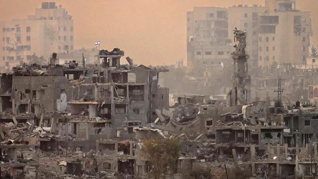 An Israeli flag flies on top of destroyed building next to a mosque in northern Gaza. Picture: Christopher Furlong/Getty Images