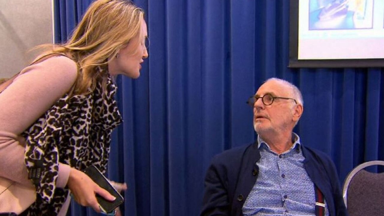 A woman confronts Philip Nitschke at a euthanasia conference. Picture: Nine.
