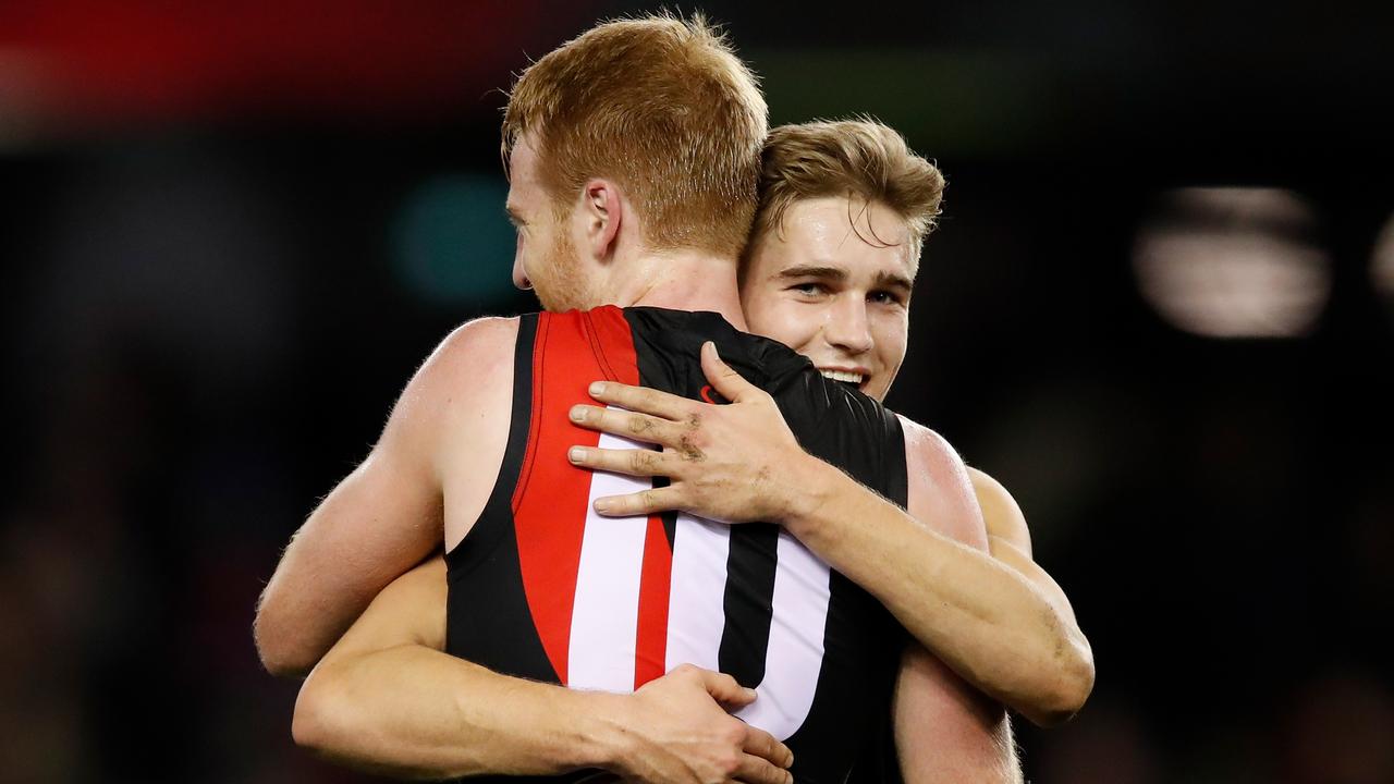 Aaron Francis embraces Matt Guelfi after the final siren on Friday night.