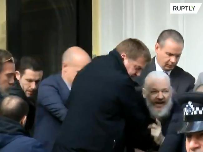 A dishevelled Julian Assange being forcibly removed from the embassy. Picture: Ruptly 