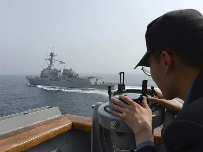 A South Korean navy sailor watches the destroyer USS Wayne E Meyer during a joint exercises between the United States and South Korea in South Korea's West Sea on Tuesday. Picture: South Korean Defence Ministry via AP