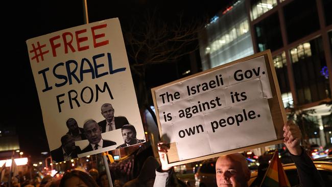 Protesters lift placards during an anti-government demonstration in Israel's central city of Tel Aviv. Picture: AFP