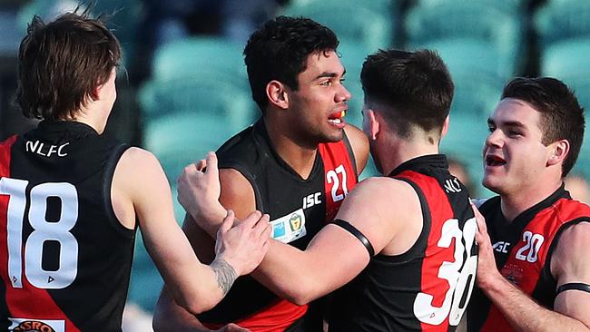 Tarry Thomas is mobbed by teammates after kicking a goal in the TSL State League grand final. Picture: Nikki Davis-Jones