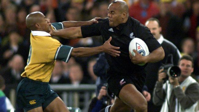 Jonah Lomu puts a fend on Wallabies halfback George Gregan during the unforgettable Bledisloe Cup game played at Stadium Australia in July, 2000. Picture: Scott Hornby