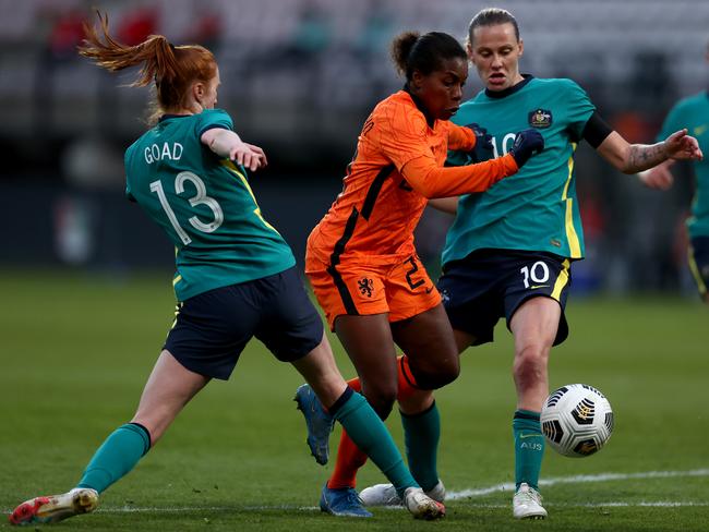 NIJMEGEN, NETHERLANDS - APRIL 13: Lineth Beerensteyn of Netherlands is tackled by Beatrice Goad and Emily van Egmond of Australia during the International Friendly match between Netherlands Women and Australia Women at Stadion de Goffert on April 13, 2021 in Nijmegen, Netherlands. Sporting stadiums around the Netherlands remain under strict restrictions due to the Coronavirus Pandemic as Government social distancing laws prohibit fans inside venues resulting in games being played behind closed doors. (Photo by Dean Mouhtaropoulos/Getty Images)