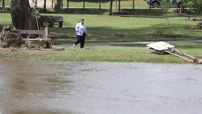 A woman looks over the flood damage in Euroa. Picture: Alex Coppel.