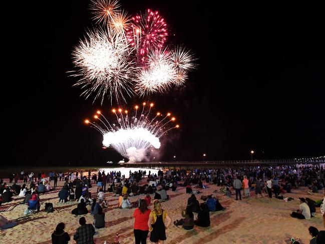 Revellers watch the 9.30 fireworks on New Years Eve in Glenelg, Adelaide, Tuesday, December 31, 2019. (Tracey Nearmy/Adelaide Advertiser)