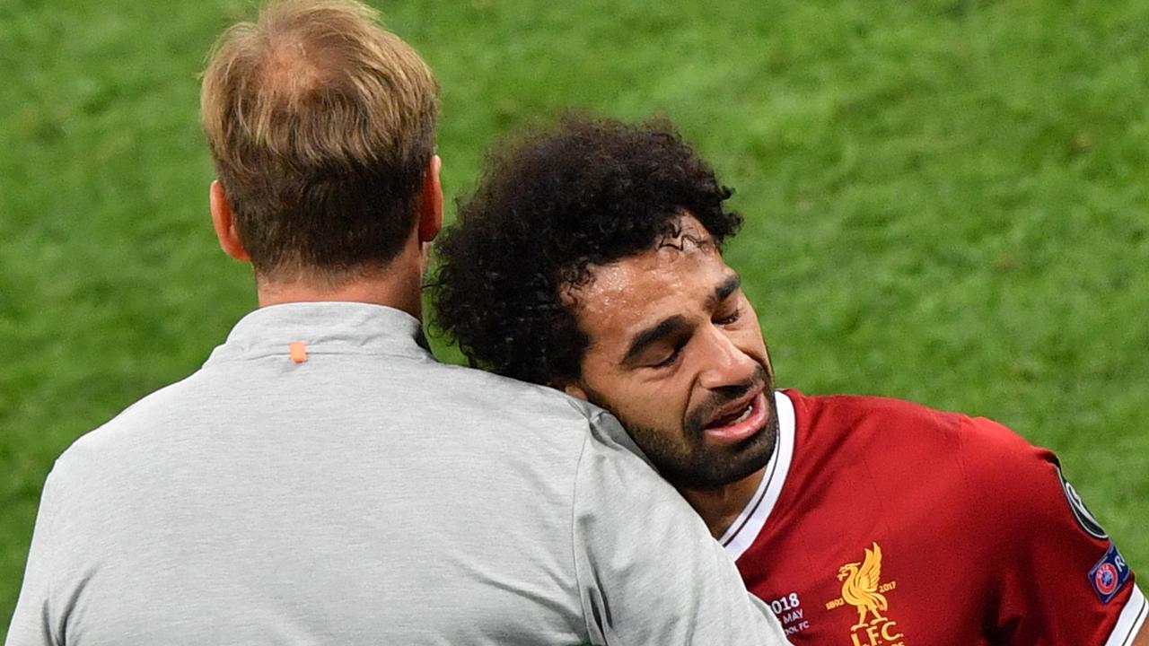 Mohamed Salah is comforted by Liverpool manager Jurgen Klopp.