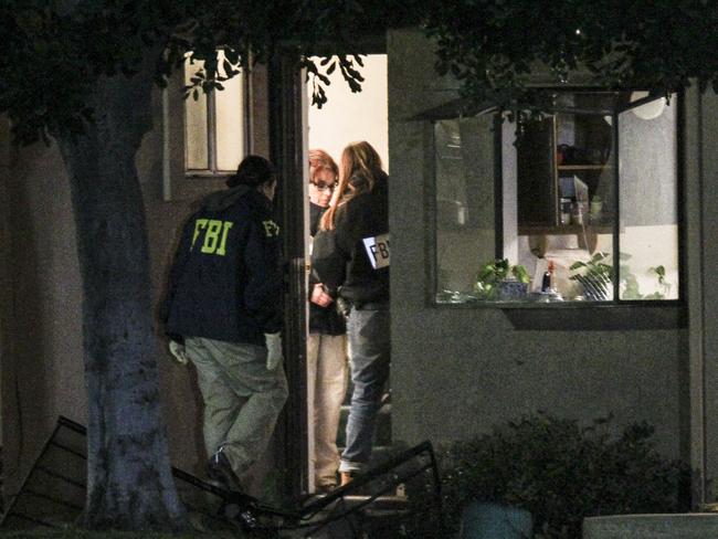 House search .. FBI agents investigate outside a home in connection to the shootings in San Bernardino. Picture: Ringo H.W. Chiu/AP