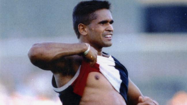 Footballer Nicky Winmar lifts his guernsey and pointing to his skin to jeering Collingwood fans. 26 April 1993.