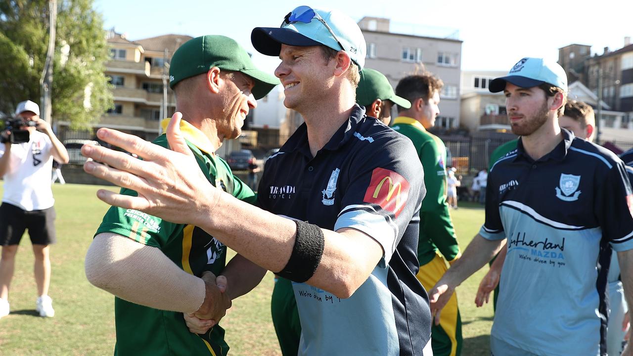 David Warner of Randwick-Petersham and Steve Smith of Sutherland embrace at the end of their grade game last week.